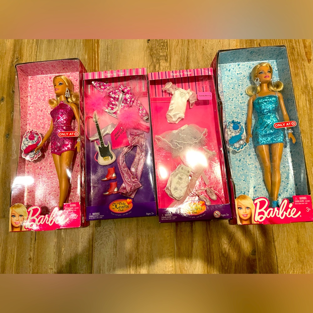 Two Barbies one pink and one blue.